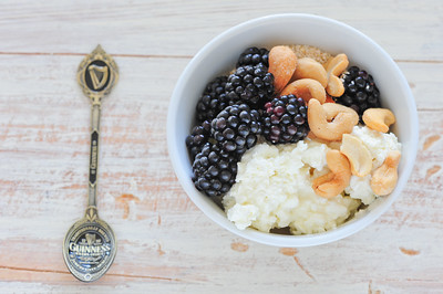 Cottage cheese, blackberries, and cashews in a bowl