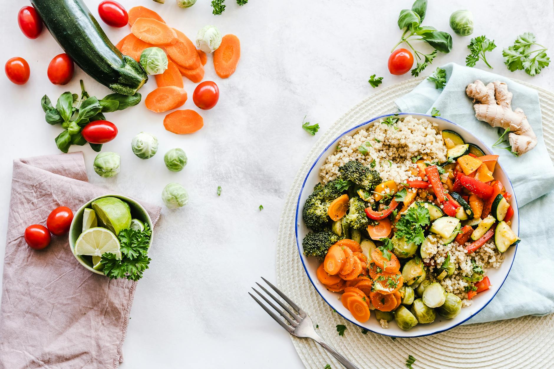 A bowl of fresh vegetables, quinoa, and more.
