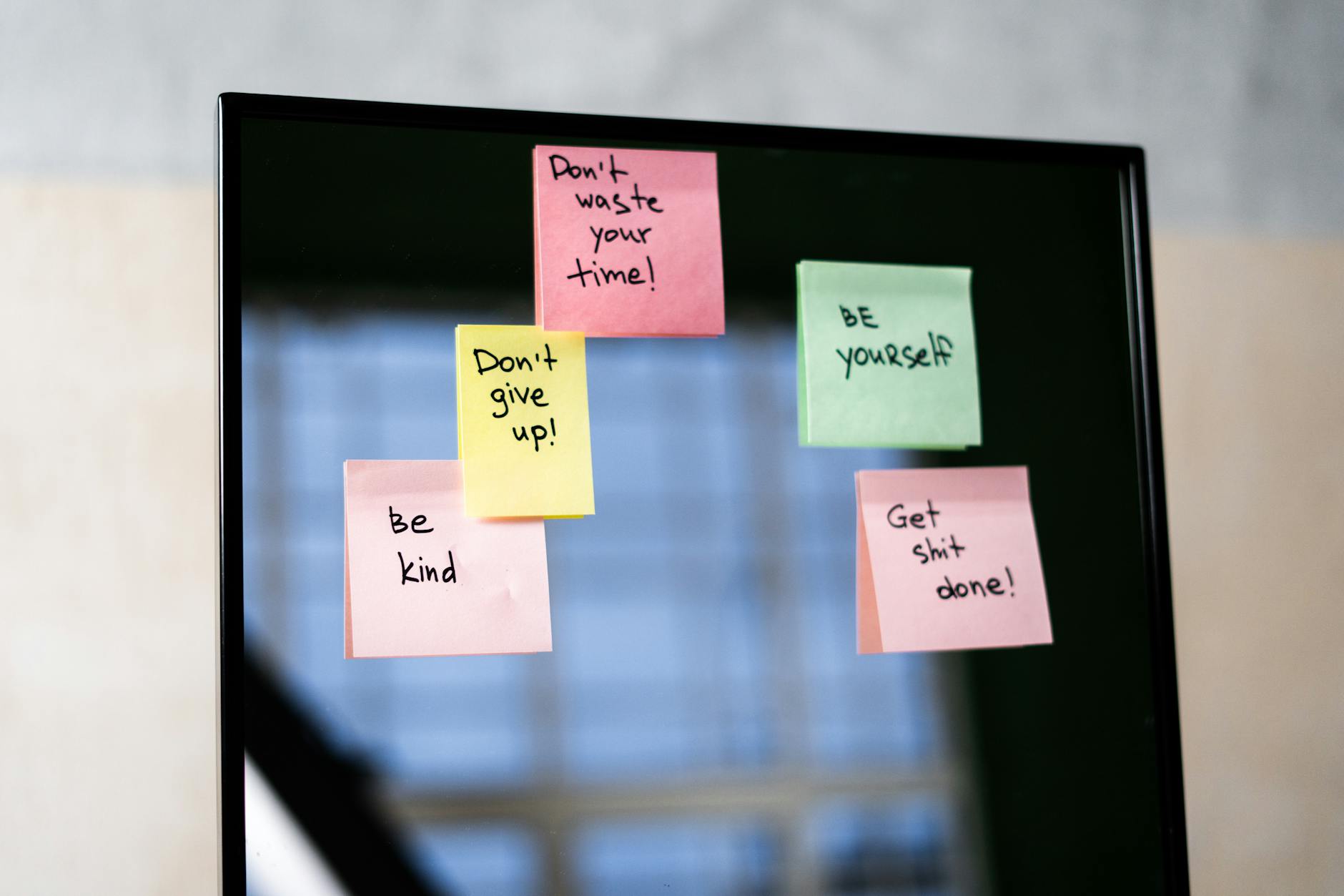 Sticky notes with positive affirmations on a mirror.