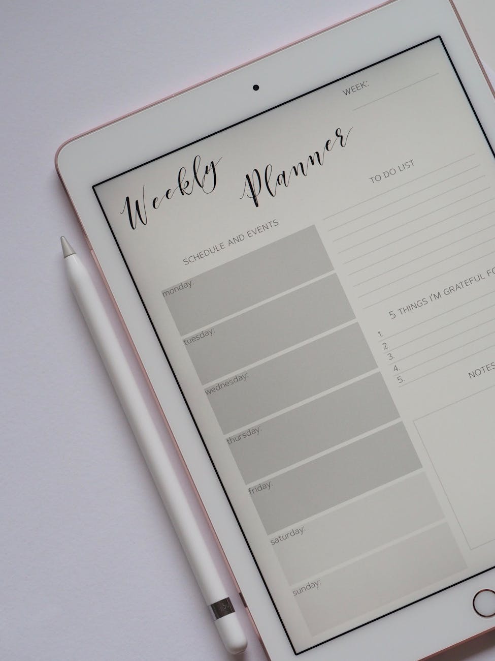 A Weekly Planner sheet is displayed on an iPad screen/
